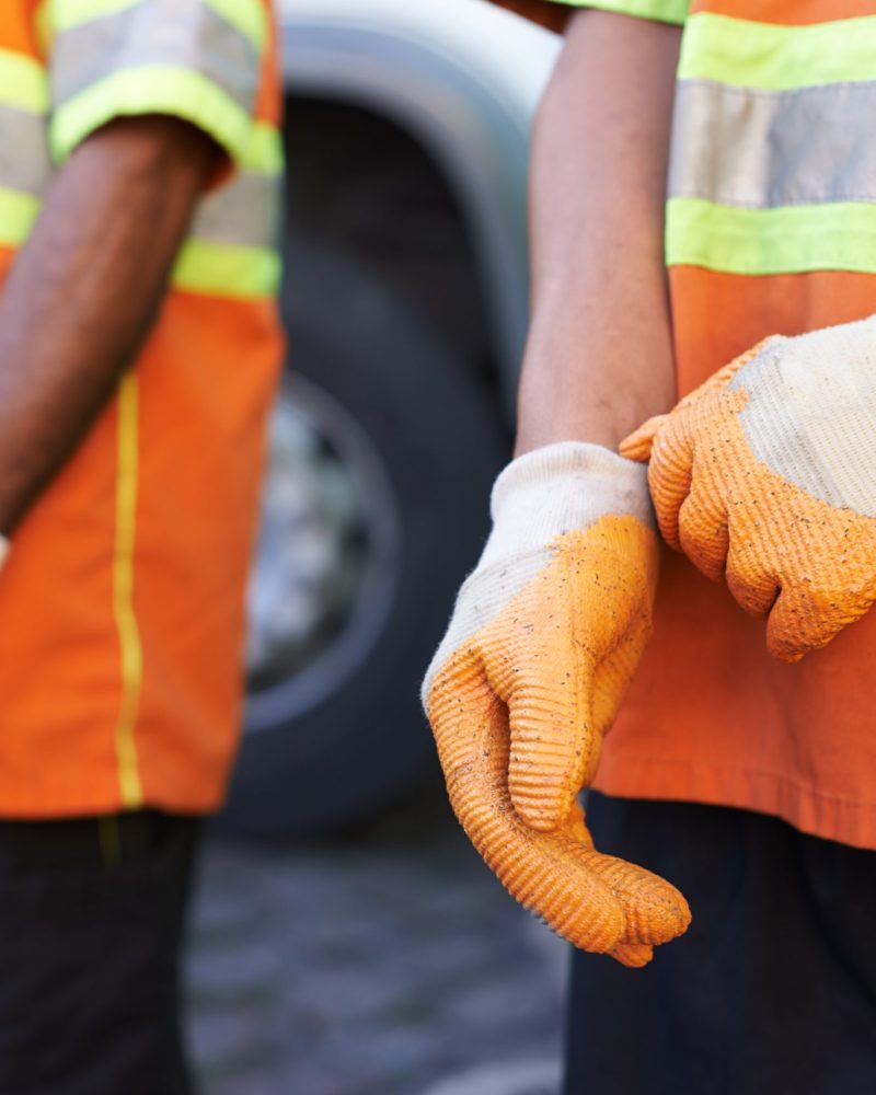 Keeping the city clean. Cropped shot of a team of garbage collectors